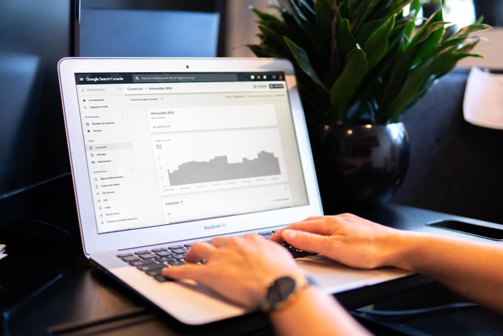 GA4 Search Console Python 자동 분석 - person using macbook air on brown wooden table